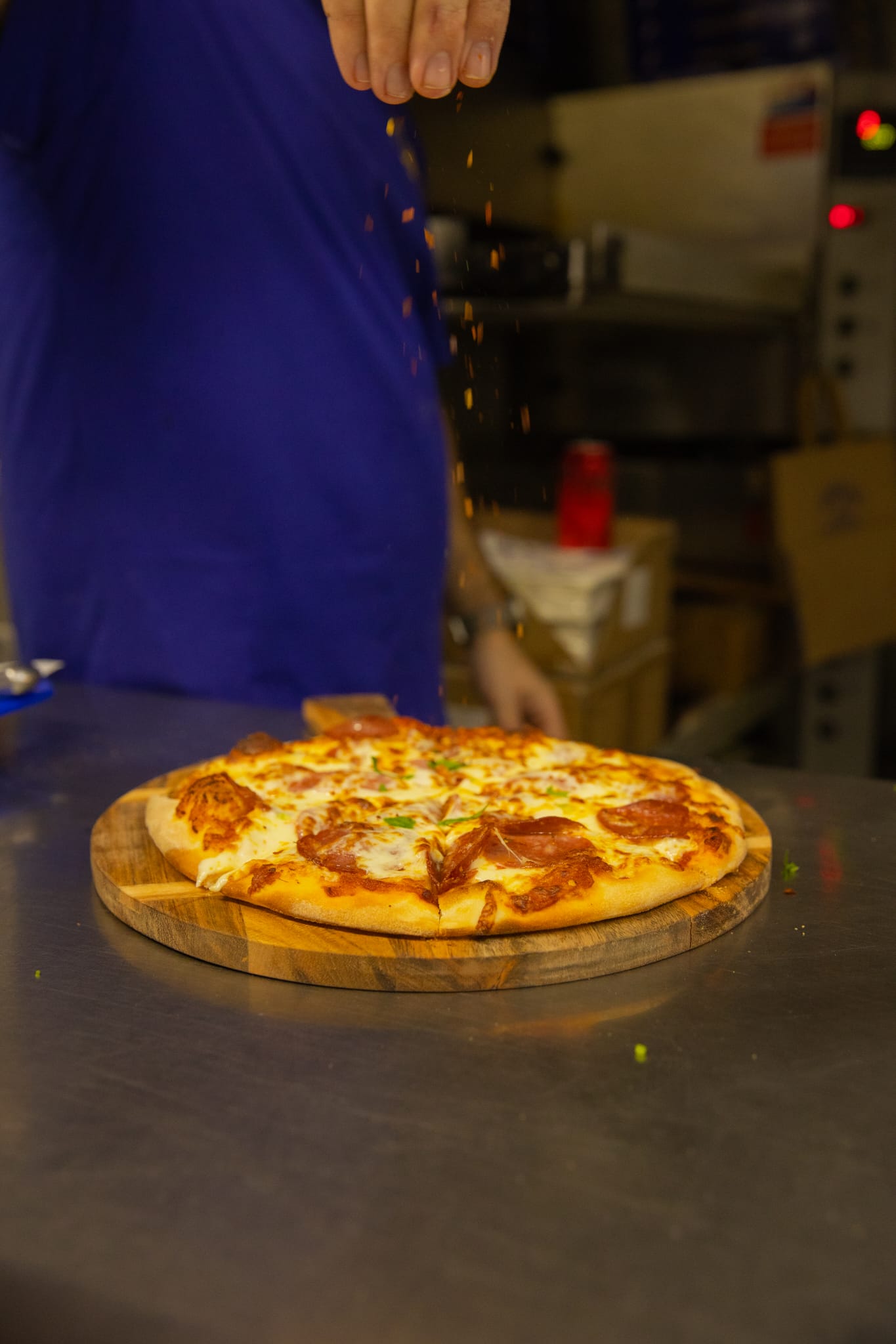 Whole wood-fired pizza on a wooden board
