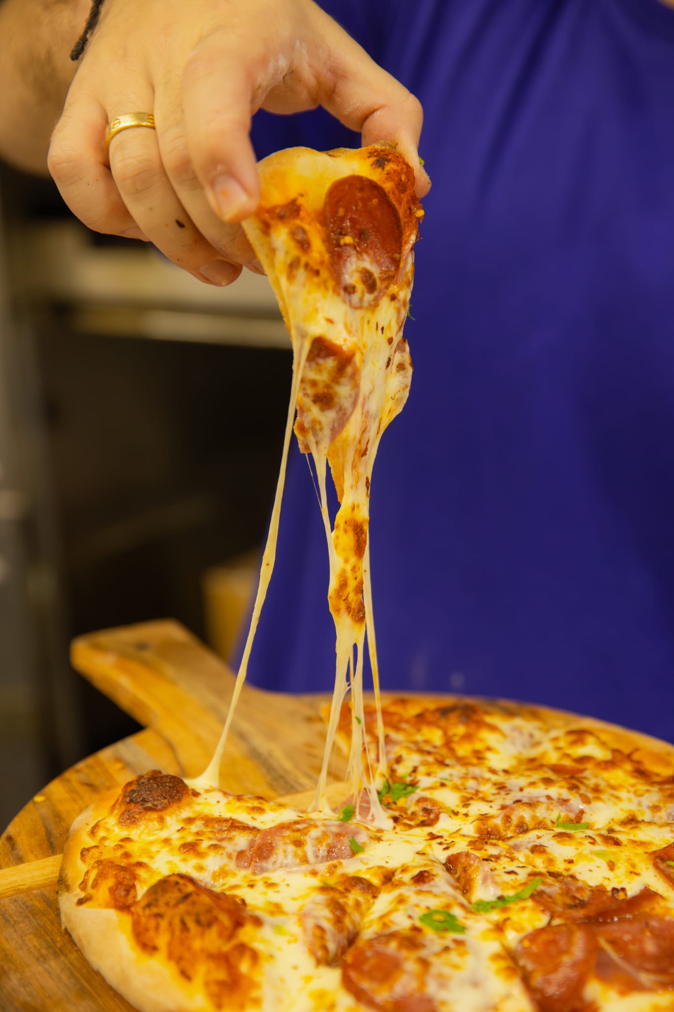 Wood-fired pepperoni pizza with a cheese pull